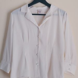 An offwhite button up blouse.